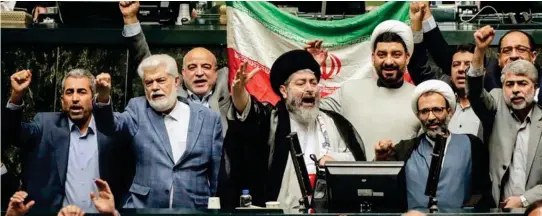  ?? ?? Battle cries: Iranian politician­s chant slogans in Tehran yesterday after the country launched hundreds of drones at Israel