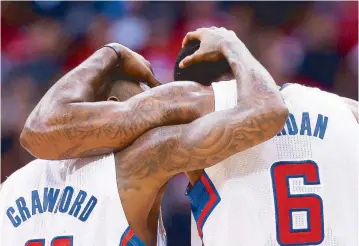  ?? AFP ?? Jamal Crawford and DeAndre Jordan of the Los Angeles Clippers embrace during the final minute against the Golden State Warriors in Game Five of the Western Conference quarterfin­als of the NBA playoffs at Staples Center in Los Angeles, California.