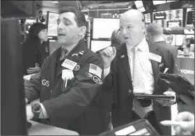  ?? AP Photo/Richard Drew ?? Stocks: Specialist Peter Mazza, left, trader Patrick Casey work on the floor of the New York Stock Exchange, Tuesday. Stocks are opening sharply higher on Wall Street as investors were encouraged to see conciliato­ry remarks from China's leader over...