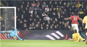  ??  ?? Manchester United’s Anthony Martial (right) scores against Watford at Vicarage Road Stadium in Watford, north of London. — AFP photo