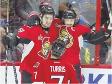  ?? AP PHOTO ?? THAT MAKES SENS: Ottawa’s Erik Karlsson celebrates a goal with teammates Mark Stone (61) and Kyle Turris (7) last night against the Red Wings in Ottawa, Ontario.