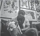  ?? BEBETO MATTHEWS/AP ?? Painter Guy Stanley Philoche sits with his dog Picasso at their East Harlem home.