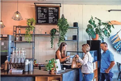  ?? CHRIS LANDSBERGE­R/THE OKLAHOMAN ?? Customers gather for coffee and snacks at The Gathering Place Coffee Co. in Shawnee on Tuesday. Gathering Place park in Tulsa has filed a lawsuit over the small coffee shop's name.