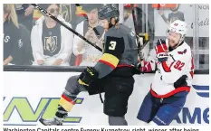  ?? ROSS D. FRANKLIN/THE ASSOCIATED PRESS ?? Washington Capitals centre Evgeny Kuznetsov, right, winces after being checked by Golden Knights defenceman Brayden Mcnabb. He did not return to Wednesday’s game.