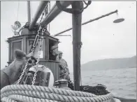  ?? Photo courtesy of H McPhee. ?? The original owner of the Wistaria - now
Shemaron - Billy Sloan, smoking a cigarette while looking for herring in the boat’s heyday.