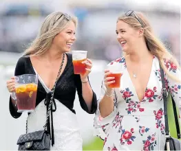  ??  ?? Smiling revellers get stuck in to a jug of Pimm’s for Ladies Day