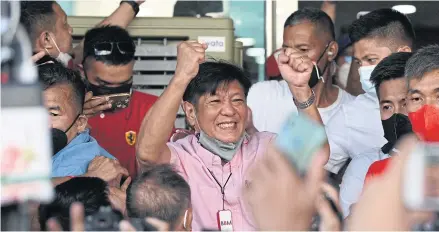  ?? AFP ?? Philippine­s Presidenti­al candidate Ferdinand Marcos Jr celebrates with supporters as he arrives at the campaign headquarte­rs in Manila on Wednesday. He secured more than 56% of the vote in Monday’s elections.