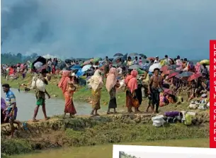  ??  ?? LEFT: Rohingya Muslims flee Myanmar’s Rakhine state. RIGHT: The army has been accused of setting homes on fire. BELOW: Police patrol the area.