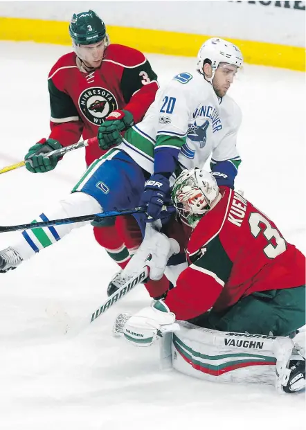  ?? — THE ASSOCIATED PRESS ?? Vancouver’s Brandon Sutter, colliding here with Minnesota goalie Darcy Kuemper during Saturday’s game in St. Paul, has struggled to put the puck in the net on power plays.