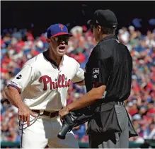  ?? HUNTER MARTIN/GETTY-AFP ?? Phillies manager Gabe Kapler argues with umpire Gabe Morales in the fourth inning of Sunday’s 6-3 loss to the Red Sox. Kapler and Bryce Harper were ejected for arguing after Harper was called out on strikes for the second time in the game.