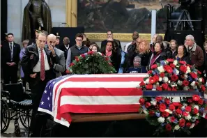  ?? AP Photo/Manuel Balce Ceneta ?? ■ Former Sen. Bob Dole, a fellow World War II veteran, salutes the flag-draped casket containing the remains of former President George H.W. Bush as he lies in state Tuesday at the U.S. Capitol in Washington.