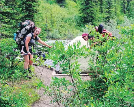  ?? MOLLY SPRAYREGEN ?? Molly Sprayregen, left, and her co-counsellor set up their tent while on a backpackin­g trip for teens in B.C.’s Mount Robson Provincial Park. Sprayregen says there is no better experience than waking up beside a mountain or glacier or river or valley that you worked hard to find.