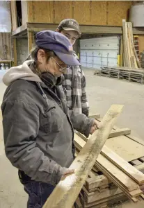  ??  ?? LEFT Brandt and associate Robert Walton examine a floorboard before shipment. RIGHT (top to bottom) Robert Walton feeds a board into the moulder. “It takes three-quarters of an inch to make a tongue-and-groove cut,” Brandt says. “So if we want a 4" board, we have to run the edge at 4 ¾ ".” • Tongue-and-groove flooring emerges from the moulder, ready to be stacking and bundled. • Boards at Sylvan Brandt are milled with a slight bevel on the bottom of the groove to make it easier to slide the next tongued board in place.