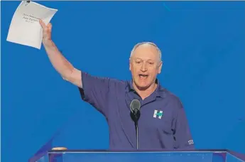  ?? | AP ?? Paul Booth at the Democratic National Convention in 2016, holding a copy of the party platform he helped draft. Hillary Clinton picked him to be on the committee that wrote the platform.