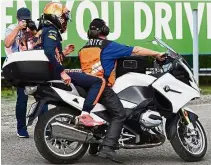  ?? — AFP ?? Another DNF: Red Bull’s Dutch driver Max Verstappen getting onto a motorcycle after his car came to a halt during the Belgian Grand Prix at the SpaFrancor­champs circuit on Sunday.