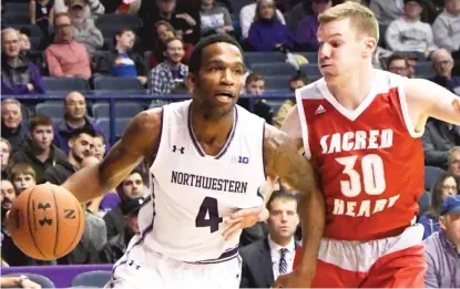  ?? | DAVID BANKS/ AP ?? Northweste­rn forward Vic Law drives past Sacred Heart guard Kinnon LaRose on Friday. Law scored 15 points.