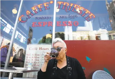  ?? Paul Chinn / The Chronicle ?? Paulette Baker, a regular of Caffe Trieste, sips an Americano espresso outside the North Beach institutio­n.
