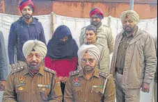  ?? HT PHOTO ?? Accused Mandeep Kaur, 32, (face covered) in police custody in Kapurthala on Wednesday.