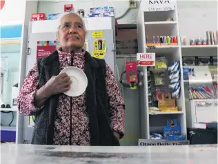  ?? PHOTO: TOM KITCHIN ?? Safe now . . . Old Town Store owner Utia Lafita holds the saucer she used to scare off a wouldbe robber.