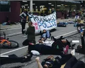  ?? JIM MONE — THE ASSOCIATED PRESS ?? Protesters hold a die-in outside the Hennepin County Family Justice Center where four former Minneapoli­s police officers appeared at a hearing Friday.