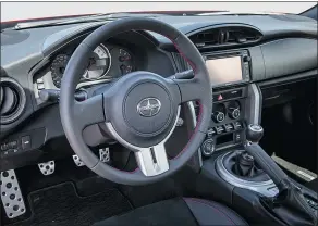  ??  ?? The parts of the Scion FR-S that the driver engages with regularly — seats, steering wheel and gear shifter — are driver-oriented.