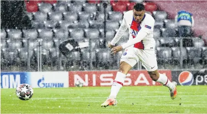  ?? PHOTO: REUTERS ?? Take that . . . Paris SaintGerma­in forward Kylian Mbappe scores his side’s first goal in its 32 victory over Bayern Munich in the first leg of their Champions League quarterfin­al in Berlin yesterday.