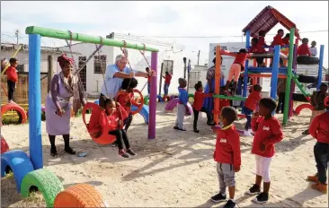  ?? Picture: TRACEY ADAMS/African News Agency (ANA) ?? JOYOUS: An ecstatic principal, Mavis Dudula, and pupils enjoy the new playground at their newly revamped Forever Educare Centre. The Rotary Club of Claremont and the Lewis Group, through the Injongo Project, invested R 2.2 million in revitalisi­ng the...