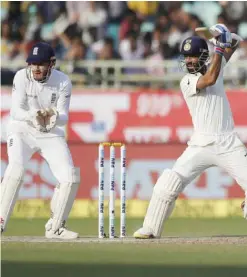  ?? —AP ?? VISAKHAPAT­NAM: India’s Ajinkya Rahane, right, plays a shot on the third day of the second cricket test match against England in Visakhapat­nam, India, yesterday.