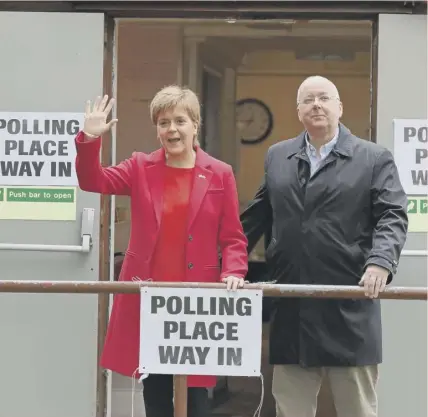  ??  ?? 0 SNP leader Nicola Sturgeon and the party’s chief executive, her husband Peter Murrell, leave a polling station