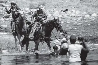  ?? FELIX MARQUEZ AP ?? File photo shows mounted U.S. Border Patrol agents attempting to stop Black migrants crossing the border into Texas in September.