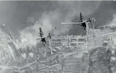  ?? ?? ■ Handley Page Halifaxes of 35 Squadron bombing the German battlecrui­sers Scharnhors­t and Gneisenau in dry dock, Brest, on 18 December-1941. (HMP)