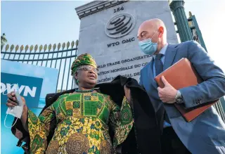  ?? AFP PHOTO ?? FIRST WOMAN CHIEF
New Director-General of the World Trade Organizati­on Ngozi Okonjo-Iweala (left) walks at the entrance of the WTO following a photo-op upon her arrival at the WTO headquarte­rs to takes office on March 1, 2021 in Geneva.