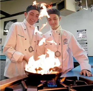  ??  ?? Students Kapila Tohiariki, left, and Ed Langlands at work in the Southland Boys’ High School’s catering classroom in Invercargi­ll. The pair won silver medals at the Paul Krantzcke Internatio­nal Schools’ Culinary Challenge on the Gold Coast recently. ROBYN EDIE/STUFF