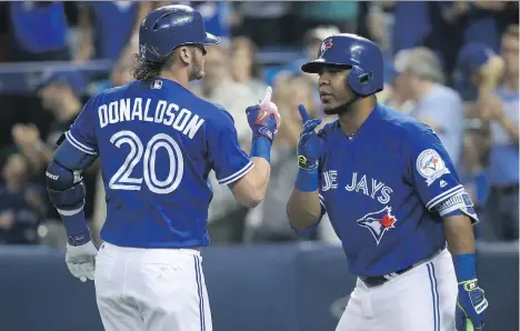  ?? TOM SZCZERBOWS­KI/GETTY IMAGES/FILES ?? Edwin Encarnacio­n of the Toronto Blue Jays, right, a pending free agent, has performed well enough to warrant a four-year contract worth between $80 and $100 million. Third baseman Josh Donaldson is due for a hefty raise next year.