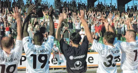  ?? FOTO: STEFAN PUCHNER/DPA ?? Nach dem Überraschu­ngserfolg über den 1. FC Nürnberg 2001 lassen sich die Ulmer Spieler von den Fans im Donaustadi­on feiern.