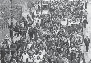  ?? RYAN GARZA, DETROIT FREE PRESS ?? Hundreds of people march along West Vernor Highway in Detroit on Thursday after a “Day Without Immigrants” rally at Clark Park. About 100 businesses closed in Michigan.