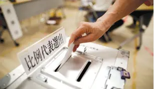  ?? (Issei Kato/Reuters) ?? A VOTER CASTS a ballot during Japan’s upper house election in Tokyo.