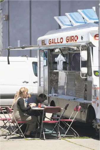  ?? Photos by Lea Suzuki / The Chronicle ?? Jennie Lennick of San Francisco, who owns a neighborin­g business, came over for a meal at El Gallo Giro. The truck is all the family that owns it has left after a fire destroyed their home.