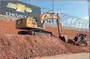  ?? Tyler head/aMs ?? Crews have started carving into the embankment in turns 1 and 2 at Atlanta Motor Speedway in Hampton to yield the steeper 28-degree banking.