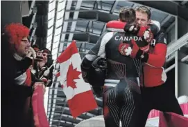  ?? STEVE RUSSELL TORONTO STAR ?? Jesse Lumsden hugs Alexander Kopacz after Justin Kripps and Alexander Kopacz of Canada tied for the gold medal with Germany on Monday.