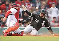  ?? AP Photo/michael Dwyer ?? ■ Chicago White Sox’s Jose Abreu (79) is safe at home plate against Boston Red Sox’s Christian Vazquez on the single by Luis Robert Saturday during the 10th inning of a baseball game in Boston.