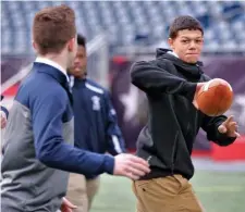  ?? NANCY LANE / BOSTON HERALD ?? READY TO GO: St. Mary’s running back Jalen Echevarria tosses the ball to teammate Connor Donohue during Tuesday’s Super Bowl Media Day at Gillette Stadium.