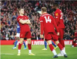  ?? (Reuters) ?? LIVERPOOL MIDFIELDER James Milner (left) celebrates after scoring on a stoppage-time penalty to give the first-place Reds a 2-1 home victory over Leicester on Saturday.