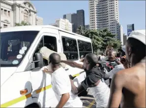  ?? PICTURE: GCINA
NDWALANE ?? PRESSURED: Taxi drivers throw objects at a colleague’s taxi, accusing him of operating while they are striking. Most South Africans use minibus taxis to get to work, but the government is subsidisin­g air travel instead of providing decent public transport infrastruc­ture, the writer says. The poor therefore bear the brunt of the delivery failure.