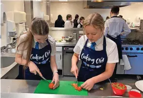  ?? ?? Chop, chop It’s all hands on deck in the college training kitchen