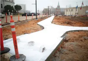  ?? Staff photo by Kelsi Brinkmeyer ?? ■ The recent work being done on the courthouse square project includes laying sidewalks and curbs, above.