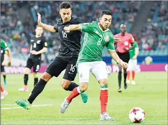  ??  ?? Mexico’s Marco Fabian (right), and New Zealand’s Dane Ingham vie for the ball during the Confederat­ions Cup Group
A soccer match between Mexico and New Zealand, at the Fisht Stadium in Sochi, Russia on June 21. (AP)