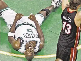  ?? Photo by AP ?? Chances are Celtics’ Kevin Garnett is uttering a four-letter word (hint: it’s not ‘hoop’) as he hits floor while battling for rebound against Mike Miller and Heat in Game 3 Friday.