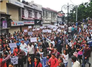  ?? AFP ?? Residents take part in a protest demanding justice after a teenage girl was raped and murdered in Shimla yesterday.