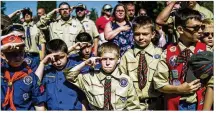  ?? ASSOCIATED PRESS ?? Boy Scouts and Cub Scouts salute during a Memorial Day ceremony in Linden, Mich. The Boy Scouts of America will let girls join Cub Scouts next year and create a program for older girls in 2019.